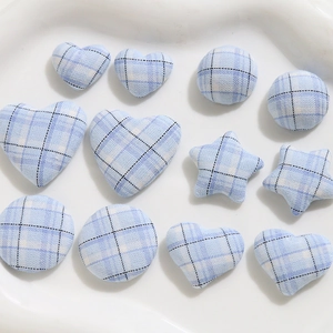 Detail of blue and white plaid fabric buttons in heart, star, and round shapes
