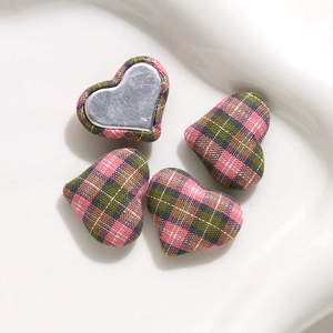 Close-up of heart-shaped plaid fabric buttons with metal back for DIY crafts