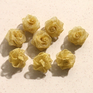 Macro shot of 8-piece gold wire mesh rose charms for elegant DIY jewelry making projects