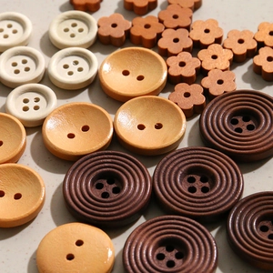 Primer plano de varios botones de madera redondos y florales con texturas naturales para DIY