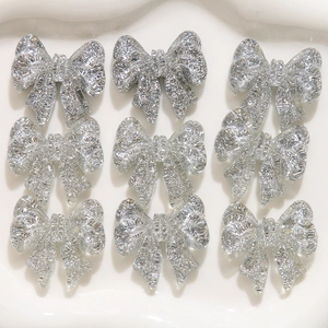 Set of nine silver glitter resin bowknot DIY accessories for earrings and phone cases