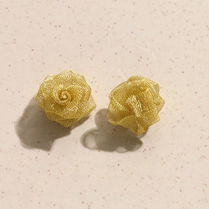 Detail of champagne gold woven wire rose earrings with layered mesh petals texture