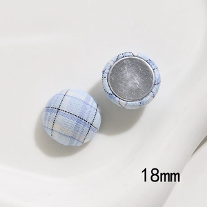 Detail view of 18mm light blue plaid fabric button with high-quality metal back
