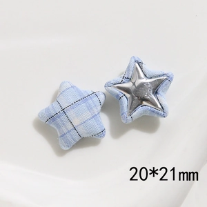 Detail of pink and blue fabric plaid star buttons with metal inserts for DIY clothing