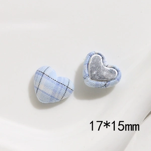 Detail view of 17x15mm heart-shaped fabric buttons with blue plaid pattern and metal base
