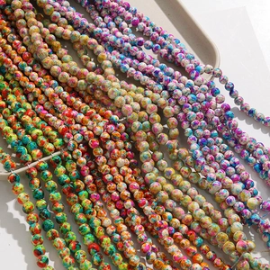 Detailed close-up of 8mm multicolored crackle ink texture round beads for DIY jewelry