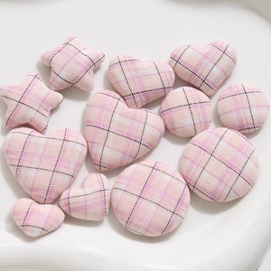 Pink plaid fabric covered buttons in star, round and heart shapes for DIY sewing projects