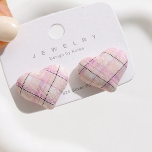 Close-up of heart-shaped pink plaid fabric earrings with S925 silver needles