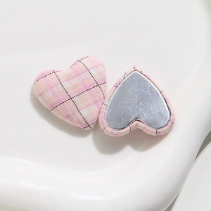 Detail of pink plaid fabric heart-shaped buttons with flat metal magnetic backing
