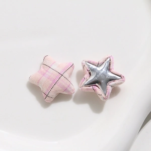 Detailed view of pink plaid fabric star buttons with silver mirror inlay for DIY projects