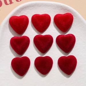 Detailed view of nine red velvet heart-shaped resin charms arranged in a grid on a tray