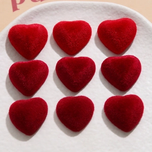 Detailed view of red flocked velvet heart resin charms for DIY earring and craft projects