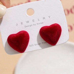Macro view of red velvet heart earrings with high-quality 925 sterling silver posts