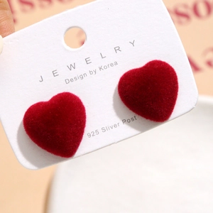 Detail of red velvet heart earring with 925 silver post on white jewelry card