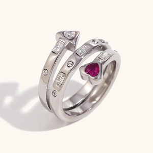 Macro shot of triple-layer silver ring featuring heart detail and mixed-cut zircons