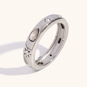 Silver geometric ring with pear-cut stone and star-engraved zircon details