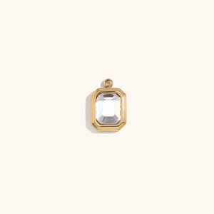 Macro shot of 18K gold plated rectangular emerald cut crystal pendant with gold bezel setting