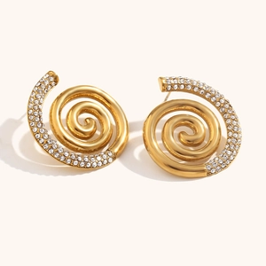 Macro shot of 18K gold plated spiral earrings with sparkling crystal pavé details