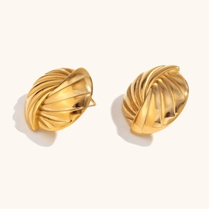 Macro shot of 18K gold plated croissant style dome earrings with textured ribbing