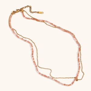 Close-up of 18K gold double layer necklace with peach sunstone beads and K18 hallmark tag
