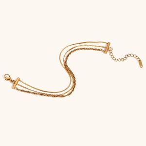 Detailed view of 18K gold plated multi-layer anklet with snake and curb chains and K18 tag
