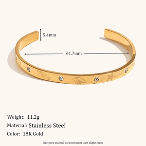 18K gold plated stainless steel bangle with embossed seahorse and starfish patterns