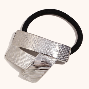 Modern origami style hair tie with silver geometric metal blocks and black elastic cord