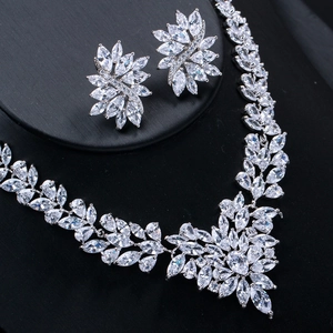 Close-up of elegant marquise zirconia jewelry set with silver flower necklace and earrings