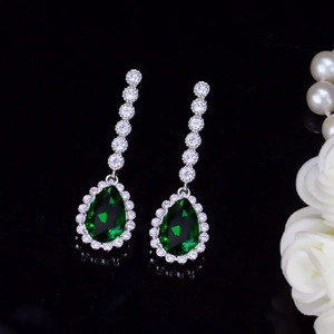 Detailed view of teardrop emerald-green cubic zirconia earrings with micro-pave diamonds