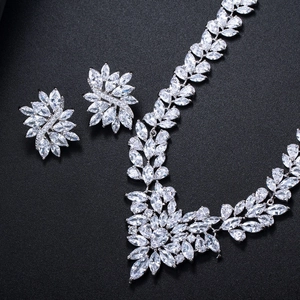 Macro detail of silver jewelry set with marquise cut zircon in floral leaf pattern