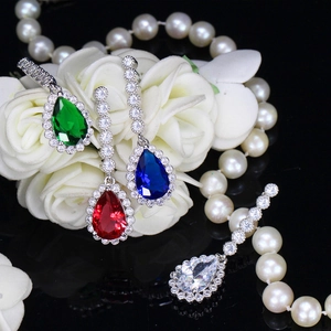 Detailed view of teardrop zircon earrings in emerald, ruby, sapphire and clear colors