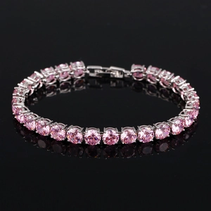 Détail d'un bracelet tennis avec zircons roses ronds et monture à quatre griffes argentée