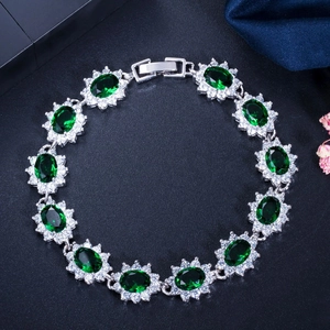 Détail d'un élégant bracelet plaqué or blanc 18 carats aux pierres vert émeraude