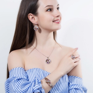 Elegant silver jewelry set with multicolor gemstones featuring necklace, ring and earrings