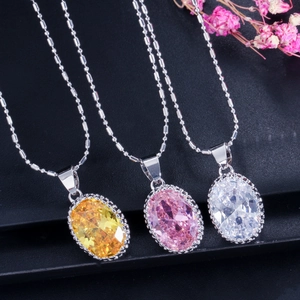 Macro shot of oval cut gemstones in yellow, pink, and white on silver bead chains