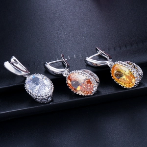 Macro detail of oval cut zircon jewelry pendants with elegant halo setting in three colors