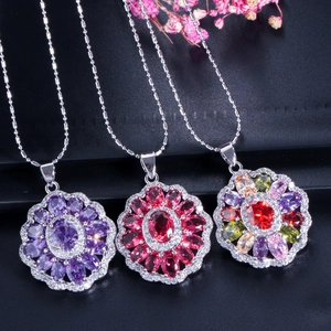 Macro detail of floral jewelry set with multi-layered colorful gemstones and fine silver chain