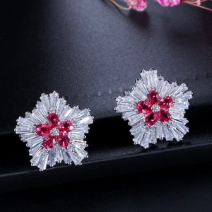 Exquisite snowflake earrings with red pear-cut center and sparkling clear petals