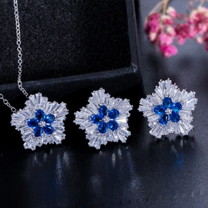 Macro detail of jewelry set with blue teardrop crystals and radiant zircon inlays