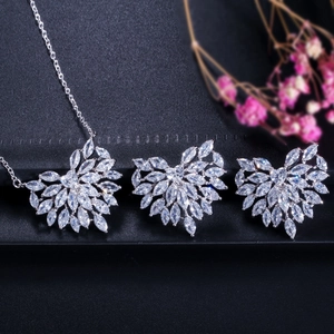 Elegant heart zirconia jewelry set with necklace and stud earrings on dark background