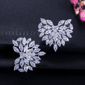 Detailed macro view of heart-shaped zircon earrings with marquise-cut stones and silver base