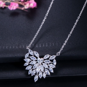 Elegant heart-shaped zircon necklace set with marquise cut stones on a black leather background