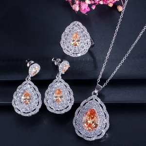Detailed set of pear-cut orange zircon jewelry with a ring, necklace, and earrings