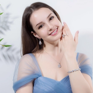 Elegant silver-tone teardrop jewelry set with necklace, earrings, bracelet and ring on model