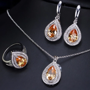 Macro shot of silver jewelry set with amber teardrop stones and zircon accents