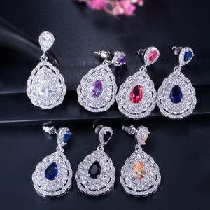 Detail view of pear-cut zircon earrings in seven colors with sparkling diamond halo