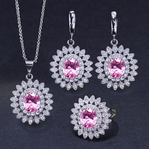 Detailed view of pink zircon sunflower necklace and earring set with silver-tone finish