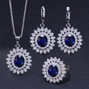Elegant gold-plated jewelry set with blue sapphire oval stones and sunflower zircon halo