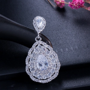 Macro shot of silver pear-shaped pendant necklace with clear cubic zirconia pavé setting