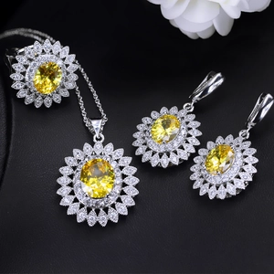 Detail view of sunflower jewelry set with yellow zircon stones on black display